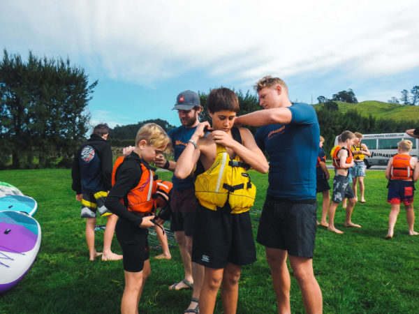 Waimarino Adventure Park | Instructor Helping Child with PFD